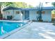 Backyard pool with concrete decking, privacy, and a desert cactus at 1501 7Th Se St, Winter Haven, FL 33880