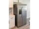 Stainless steel refrigerator with water dispenser and adjacent white cabinets at 1501 7Th Se St, Winter Haven, FL 33880