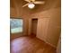 A bedroom with wood floors, a ceiling fan, and a closet with double doors at 1003 Clearpointe Way, Lakeland, FL 33813