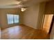 Bright and airy bedroom with hardwood floors, ceiling fan, and a large window at 1003 Clearpointe Way, Lakeland, FL 33813