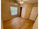 Bedroom featuring wood flooring, fan and closet with sliding doors at 1003 Clearpointe Way, Lakeland, FL 33813