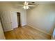 Bedroom with wood floors, ceiling fan and double door closet at 1003 Clearpointe Way, Lakeland, FL 33813