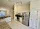 Bright kitchen featuring white cabinets, stainless steel appliances, and granite countertops at 1003 Clearpointe Way, Lakeland, FL 33813