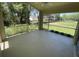 Screened-in lanai with a view of the backyard, surrounded by mature trees and lush landscaping at 1003 Clearpointe Way, Lakeland, FL 33813