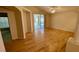 Open living space featuring hardwood floors and sliding glass doors to a screened-in lanai at 1003 Clearpointe Way, Lakeland, FL 33813