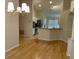 Spacious open-concept living area featuring hardwood floors and view into the eat in kitchen area at 1003 Clearpointe Way, Lakeland, FL 33813