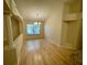 Open living space with hardwood floors and large window providing natural light at 1003 Clearpointe Way, Lakeland, FL 33813