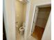 A half bath featuring a tiled floor and a separate door to the walk-in closet at 1003 Clearpointe Way, Lakeland, FL 33813