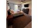 Comfortable bedroom featuring a ceiling fan, TV, dresser and a window with natural light at 6762 Pomeroy Cir, Orlando, FL 32810