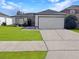Charming single-story home featuring a well-manicured lawn and attached two-car garage at 6762 Pomeroy Cir, Orlando, FL 32810