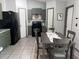 Eat-in kitchen features black appliances and tiled floors, perfect for casual dining at 6762 Pomeroy Cir, Orlando, FL 32810