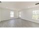 Spacious living room with bright white walls, recessed lighting, and wood-look flooring at 1204 Alafia Way, Kissimmee, FL 34759