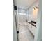 Bathroom with white marble style tile, bath tub, a black granite countertop vanity, and modern lighting at 13619 Sw 78Th Pl, Dunnellon, FL 34432
