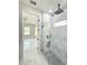 Modern bathroom featuring a glass-enclosed shower with stone floor, marble tile surround, and sleek fixtures at 13619 Sw 78Th Pl, Dunnellon, FL 34432