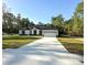 Inviting single-story home featuring a long driveway and attached two-car garage at 13619 Sw 78Th Pl, Dunnellon, FL 34432