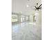 Bright living room featuring marble floors, modern ceiling fan, and three big windows at 13619 Sw 78Th Pl, Dunnellon, FL 34432
