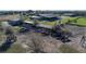 Aerial view of a farm featuring barns, paddocks, and grazing cattle at 6820 County Road 561, Clermont, FL 34714