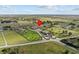 Drone shot of property featuring a wreath pin on the main house, equestrian facilities, and lush landscapes at 6820 County Road 561, Clermont, FL 34714