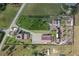 Aerial view of the property, showcasing several buildings, green lawns, and equestrian facilities at 6820 County Road 561, Clermont, FL 34714