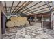 Barn interior view highlighting hay bales, a metal roof, and horse stalls with steel bar doors at 6820 County Road 561, Clermont, FL 34714