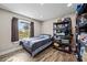Neutral toned bedroom with a window offering views of green space at 6820 County Road 561, Clermont, FL 34714