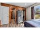 Bedroom with wood paneled accent wall, and large safe at 6820 County Road 561, Clermont, FL 34714