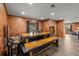 Dining area with a rustic wood table and bench set, complemented by wood-paneled walls at 6820 County Road 561, Clermont, FL 34714