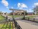 Inviting entrance to Big Dog Ranch estate with decorative gate and paved driveway at 6820 County Road 561, Clermont, FL 34714