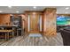 Home entryway featuring wood accents, tile flooring, a wooden front door, and an adjacent table at 6820 County Road 561, Clermont, FL 34714