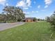 Beautiful ranch estate showcasing mature trees, sprawling lawn, and a decorative driveway at 6820 County Road 561, Clermont, FL 34714