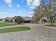 Sprawling ranch estate featuring lush landscaping, and a brick paved circular driveway at 6820 County Road 561, Clermont, FL 34714