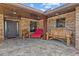 Charming covered brick entryway with artisan wood bench at 6820 County Road 561, Clermont, FL 34714
