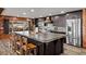 The kitchen has an island, dark wooden cabinets, granite countertops, and stainless steel appliances at 6820 County Road 561, Clermont, FL 34714