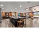 Kitchen featuring a central island, wooden cabinets, tile floors, and open layout to the living space at 6820 County Road 561, Clermont, FL 34714