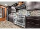 Another angle of the kitchen area showing the gas range, unique counters, and wine fridge at 6820 County Road 561, Clermont, FL 34714