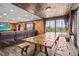 The spacious living room features wood paneling, tile floors, and large windows at 6820 County Road 561, Clermont, FL 34714