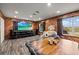 Spacious living room with wood paneled walls, recessed lighting and a large flat screen tv at 6820 County Road 561, Clermont, FL 34714