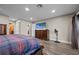 Spacious main bedroom with television and closet entrances at 6820 County Road 561, Clermont, FL 34714