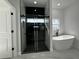 Modern bathroom featuring a separate glass shower and soaking tub with black fixtures on marble flooring at 8456 Se 164Th Pl, Summerfield, FL 34491