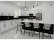 Modern kitchen with white cabinets, stainless steel appliances, and a spacious island with barstool seating at 8456 Se 164Th Pl, Summerfield, FL 34491