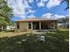 A serene backyard featuring a screened in porch, and well kept landscape at 5352 Treasure View Way, Leesburg, FL 34748