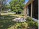 Spacious backyard with a patio area, plants, and view of surrounding trees at 5352 Treasure View Way, Leesburg, FL 34748