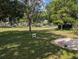 Tree covered backyard with lush green grass and shady areas at 5352 Treasure View Way, Leesburg, FL 34748