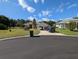 Charming home with well-manicured lawn, complemented by a blue sky at 5352 Treasure View Way, Leesburg, FL 34748