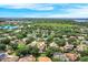 Aerial view of a residential community featuring well-maintained homes, trees, and a scenic lake at 1125 English Garden Ln, Winter Garden, FL 34787