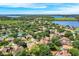 Aerial view of a neighborhood showcases a mix of homes, lush greenery, and tranquil lakes at 1125 English Garden Ln, Winter Garden, FL 34787