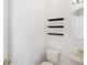 Bathroom featuring floating shelves above a toilet and a small sink at 1125 English Garden Ln, Winter Garden, FL 34787