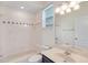 Cozy bathroom with a tub and shower combo and a large mirror above the sink at 1125 English Garden Ln, Winter Garden, FL 34787