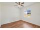 Neutral bedroom with wood floors and a window view of a fenced yard at 1125 English Garden Ln, Winter Garden, FL 34787