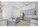 This kitchen features stainless steel appliances, ample gray cabinetry, quartz countertop, and natural light at 1125 English Garden Ln, Winter Garden, FL 34787